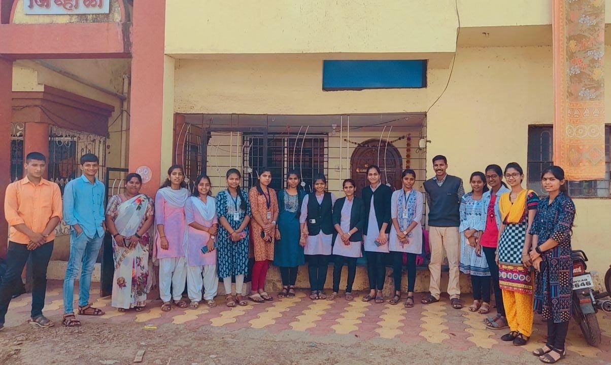 Helping Hand Save And Learn members and students posing together outside a building