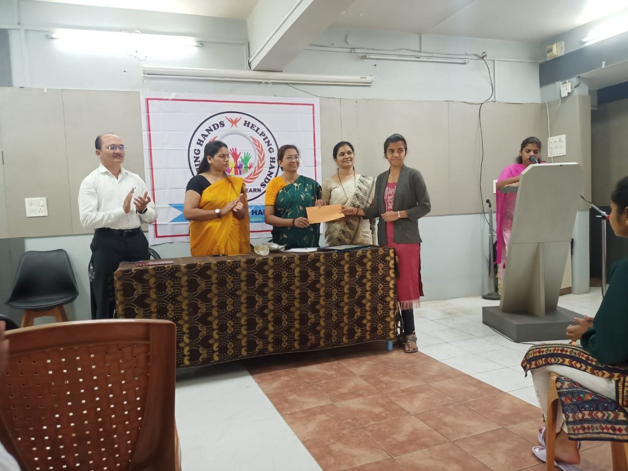 A student being honoured at a Helping Hand Save And Learn programme